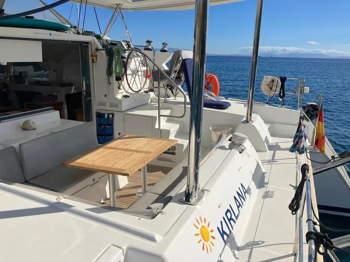 Kirlana Yacht Photos Pics Lagoon 420 catamaran deck with seating and table, sailing on a sunny day, 2006 model.