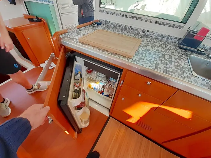 Kirlana Yacht Photos Pics Kitchen area of a 2006 Lagoon 420 yacht with open fridge and countertop.