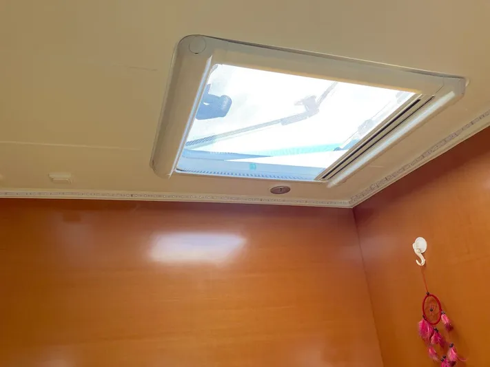 Kirlana Yacht Photos Pics Ceiling view inside 2006 Lagoon 420 yacht with skylight and decorative wall hanging.