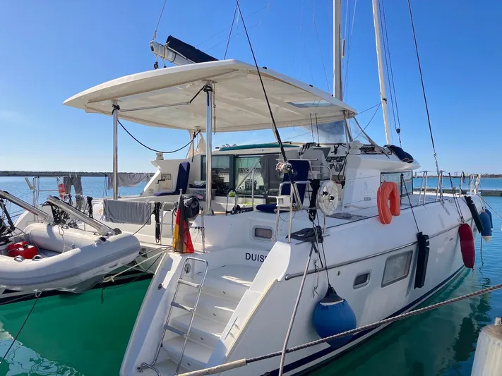 Kirlana Yacht Photos Pics 2006 Lagoon 420 catamaran docked at marina, featuring spacious deck and modern design.