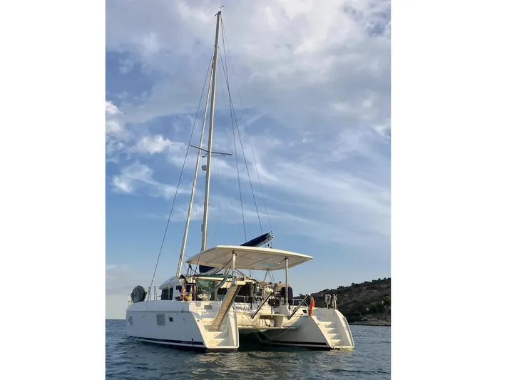 Kirlana Yacht Photos Pics 2006 Lagoon 420 catamaran sailing on calm waters under a partly cloudy sky.