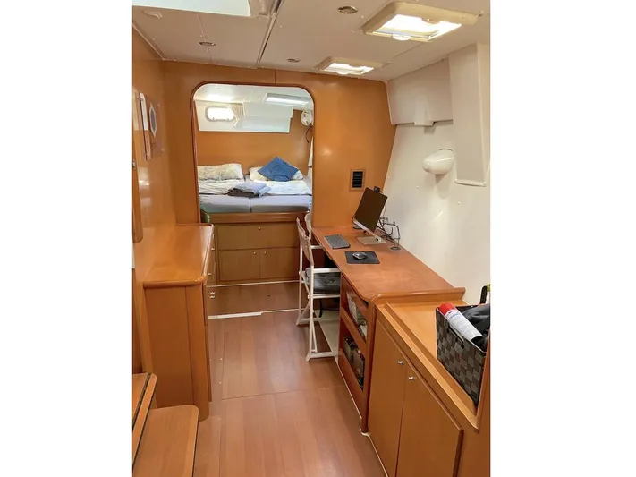 Kirlana Yacht Photos Pics Interior of 2006 Lagoon 420 yacht with wooden furnishings and cozy sleeping area.