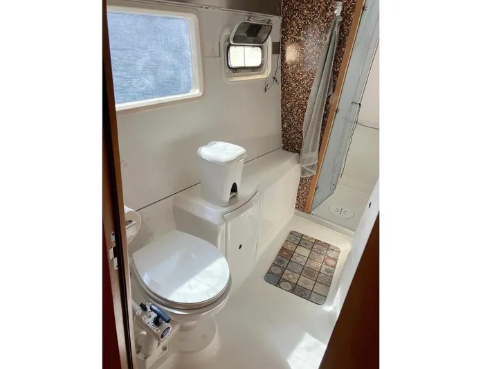 Kirlana Yacht Photos Pics Bathroom interior of 2006 Lagoon 420 yacht with shower and toilet.