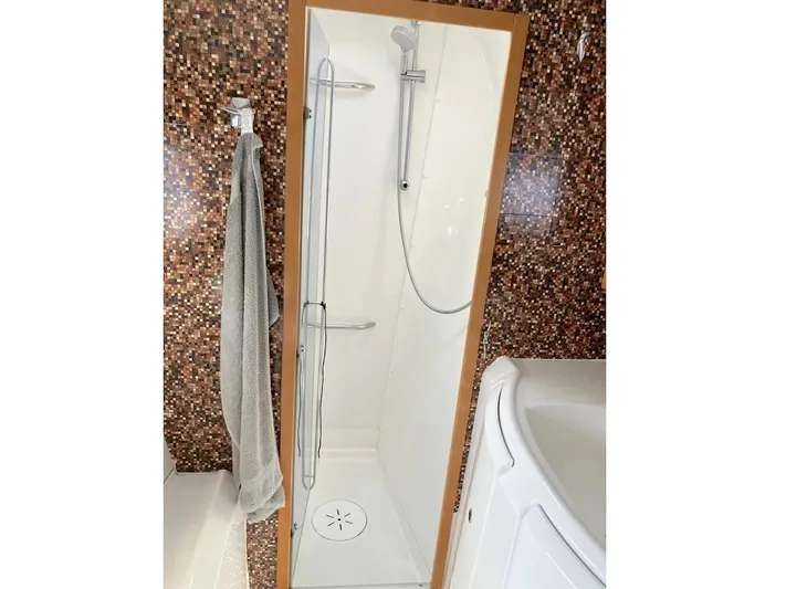 Kirlana Yacht Photos Pics Shower area in 2006 Lagoon 420 yacht with mosaic tile wall.