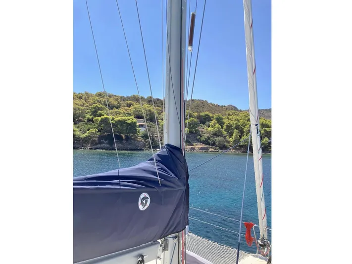 Kirlana Yacht Photos Pics Sailboat mast and rigging on a 2006 Lagoon 420, with scenic coastal backdrop.