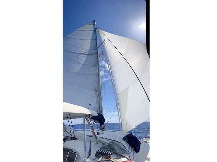 Kirlana Yacht Photos Pics Sailing on a 2006 Lagoon 420 catamaran with full sails under a clear blue sky.