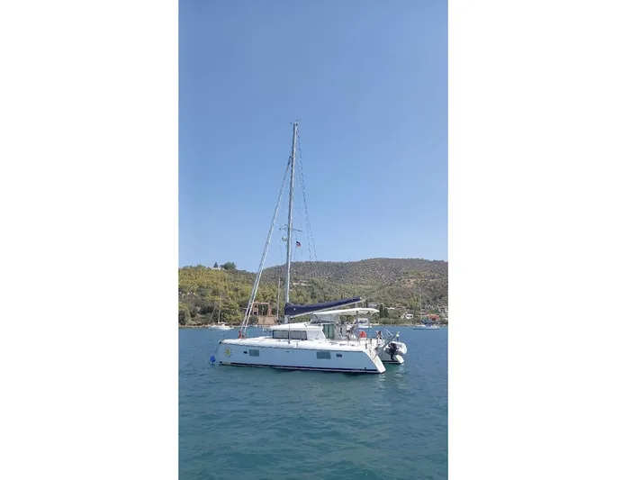 Kirlana Yacht Photos Pics 2006 Lagoon 420 catamaran sailing on calm waters under clear blue sky.