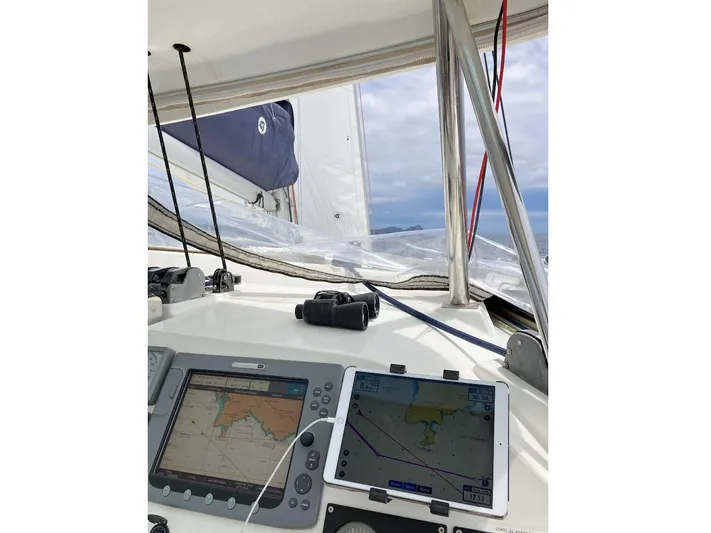 Kirlana Yacht Photos Pics Lagoon 420 sailboat cockpit with navigation screens, ropes, and ocean view.