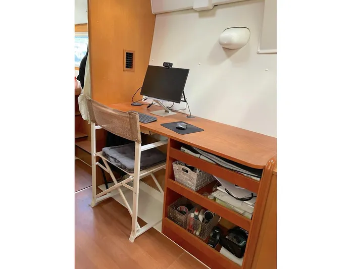 Kirlana Yacht Photos Pics Workstation setup in a 2006 Lagoon 420 yacht with wooden desk and chair.