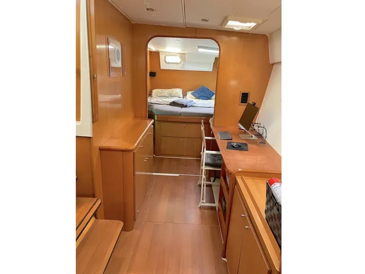 Kirlana Yacht Photos Pics Interior of 2006 Lagoon 420 yacht with wooden furnishings and cozy bedroom.