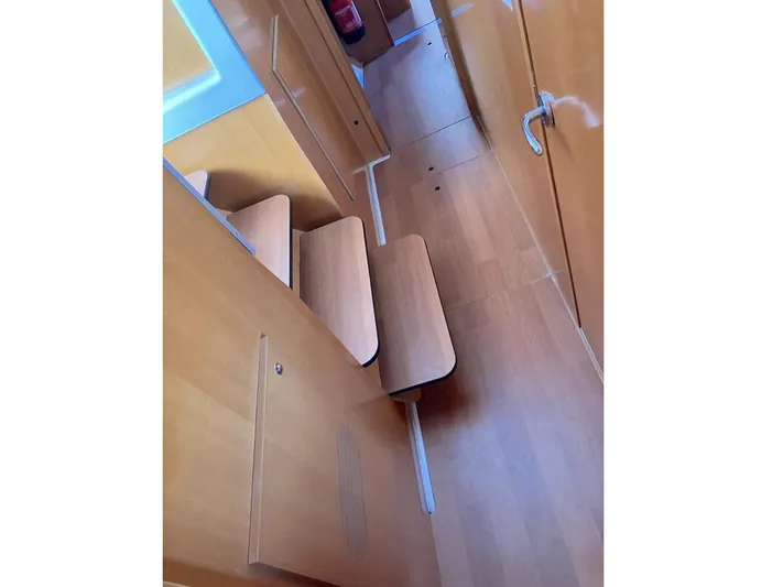 Kirlana Yacht Photos Pics Interior view of 2006 Lagoon 420 yacht, featuring wooden stairs and hallway.