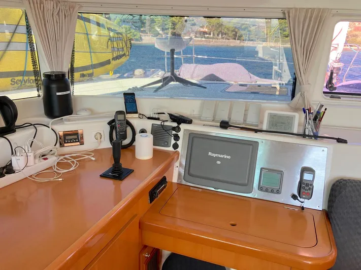 Kirlana Yacht Photos Pics Interior view of 2006 Lagoon 420 yacht cockpit with navigation equipment and scenic window view.