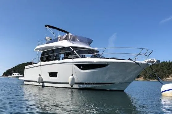  Yacht Photos Pics 2018 Jeanneau Velasco 37F yacht on calm water with clear blue sky.