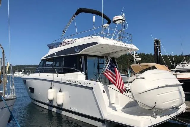  Yacht Photos Pics 2018 Jeanneau Velasco 37F yacht docked, featuring sleek design and American flag.