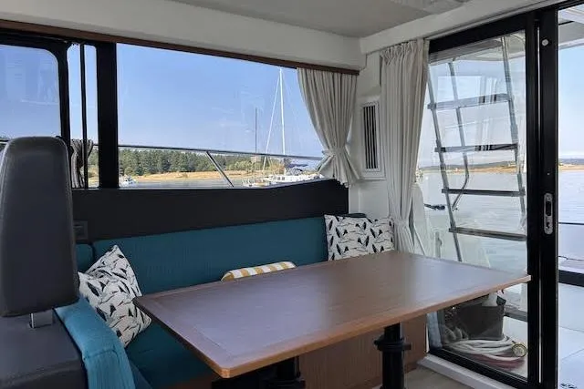  Yacht Photos Pics Interior of 2018 Jeanneau Velasco 37F yacht with dining area and scenic window view.