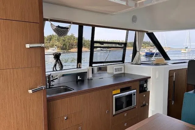  Yacht Photos Pics Interior of 2018 Jeanneau Velasco 37F yacht with modern kitchen and scenic window view.