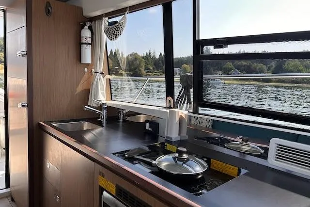  Yacht Photos Pics Interior view of 2018 Jeanneau Velasco 37F yacht kitchen with scenic water view.