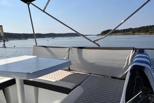  Yacht Photos Pics Flybridge seating area on 2018 Jeanneau Velasco 37F yacht, overlooking serene waters.