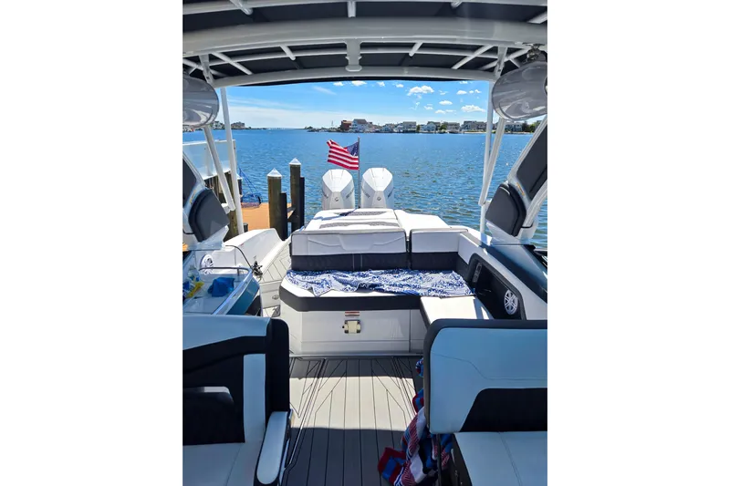  Yacht Photos Pics 2024 Monterey 305SS Super Sport boat interior with lake view and American flag.