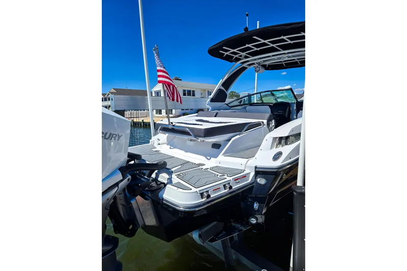  Yacht Photos Pics 2024 Monterey 305SS Super Sport boat docked, featuring sleek design and American flag.