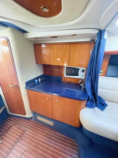  Yacht Photos Pics 2007 Cranchi Endurance 41 yacht interior with wooden cabinets and blue countertop.