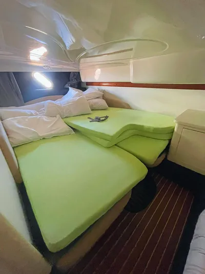  Yacht Photos Pics Interior cabin of 2007 Cranchi Endurance 41 with green cushions and wooden flooring.