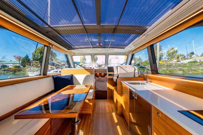  Yacht Photos Pics Luxurious interior of 2020 Coastal Craft 33 Express yacht with modern wood finishes and panoramic windows.