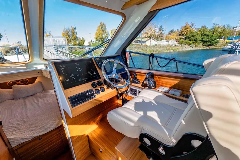  Yacht Photos Pics Interior of 2020 Coastal Craft 33 Express boat with helm, seating, and scenic water view.