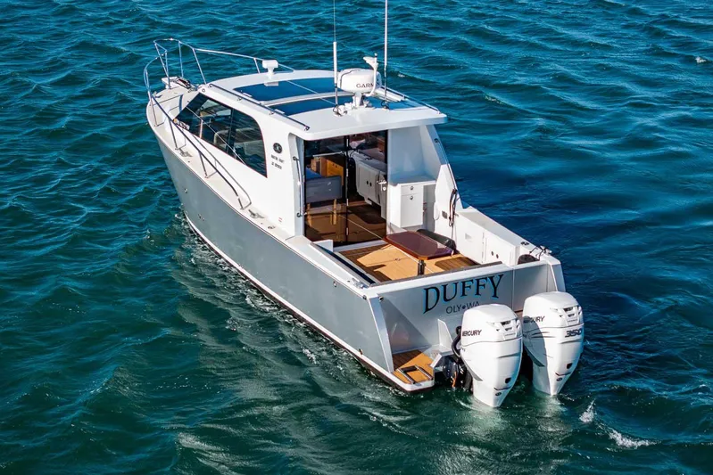  Yacht Photos Pics 2020 Coastal Craft 33 Express boat cruising on open water.