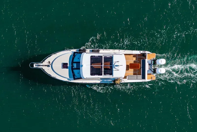  Yacht Photos Pics Aerial view of 2020 Coastal Craft 33 Express yacht cruising on open water.