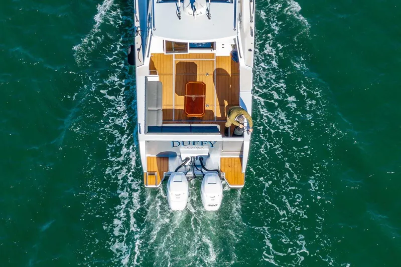  Yacht Photos Pics Aerial view of 2020 Coastal Craft 33 Express boat cruising on green water.