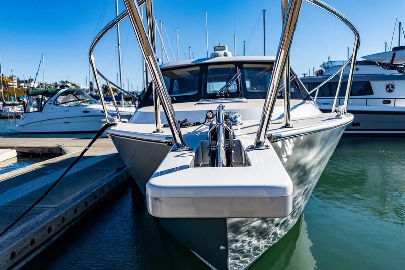  Yacht Photos Pics 2020 Coastal Craft 33 Express yacht docked in a marina, reflecting sunlight on water.
