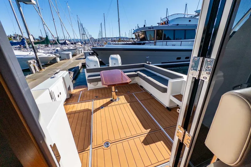  Yacht Photos Pics 2020 Coastal Craft 33 Express yacht with teak deck and seating area at marina.