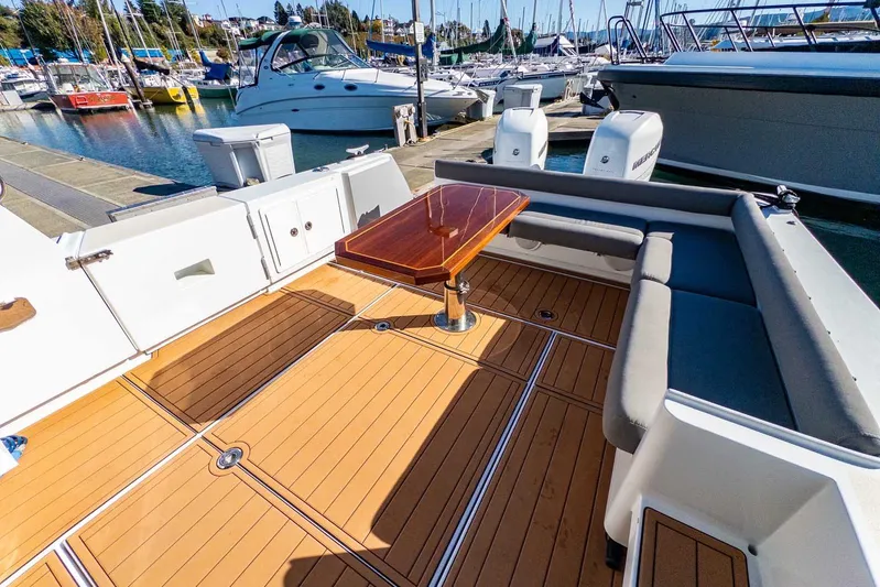  Yacht Photos Pics 2020 Coastal Craft 33 Express boat with spacious deck and seating at marina.