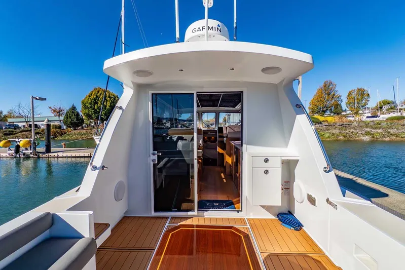  Yacht Photos Pics 2020 Coastal Craft 33 Express yacht docked, showcasing sleek design and spacious interior.