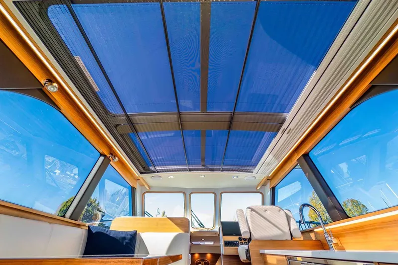  Yacht Photos Pics Interior view of 2020 Coastal Craft 33 Express yacht with panoramic windows and sleek design.