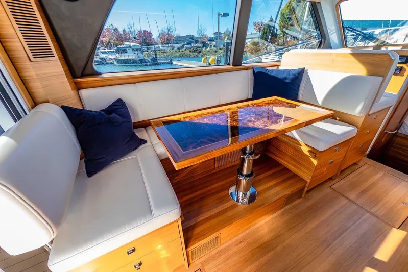  Yacht Photos Pics Luxurious interior of 2020 Coastal Craft 33 Express yacht with elegant wood and leather seating.