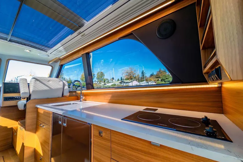  Yacht Photos Pics Luxurious interior of 2020 Coastal Craft 33 Express yacht with modern kitchen amenities.