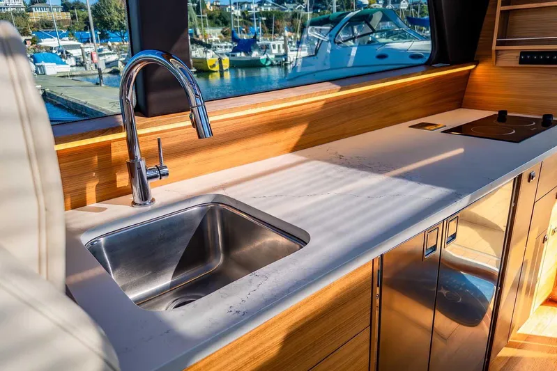  Yacht Photos Pics Modern kitchen interior of 2020 Coastal Craft 33 Express yacht with sink and stove.