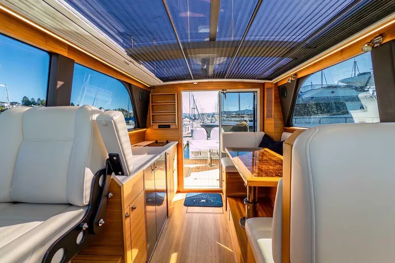  Yacht Photos Pics Interior of 2020 Coastal Craft 33 Express yacht, featuring luxurious seating and wooden finishes.