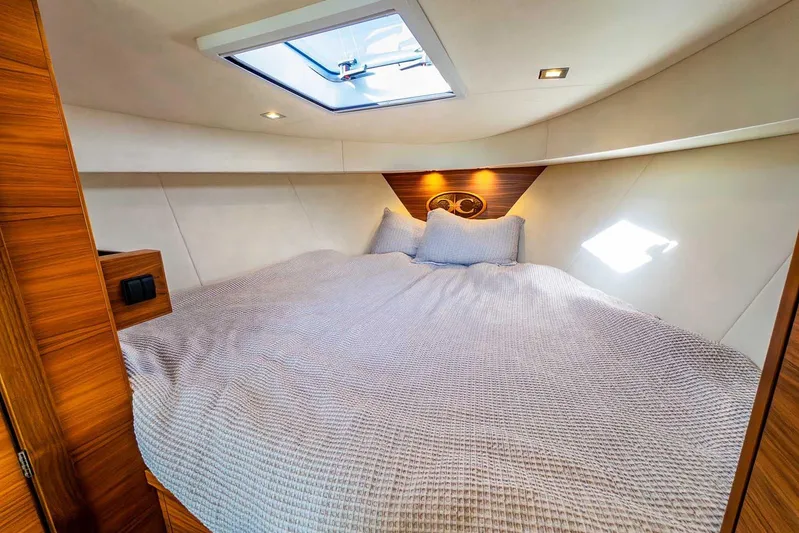  Yacht Photos Pics Luxurious cabin interior of 2020 Coastal Craft 33 Express yacht with skylight and cozy bedding.