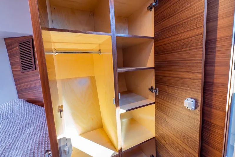  Yacht Photos Pics Interior storage of 2020 Coastal Craft 33 Express yacht with wooden shelves and closet space.