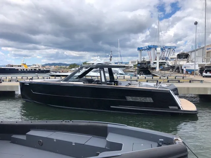  Yacht Photos Pics 2016 Fjord Open 48 yacht docked at a marina under cloudy skies.