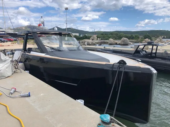  Yacht Photos Pics 2016 Fjord Open 48 yacht docked at a marina under a partly cloudy sky.