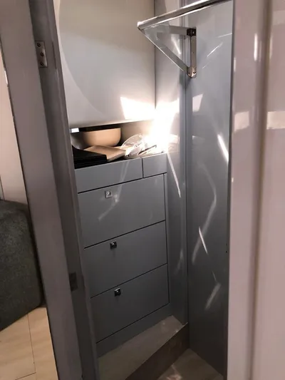  Yacht Photos Pics Compact storage area inside 2016 Fjord Open 48 yacht, featuring sleek drawers and modern design.