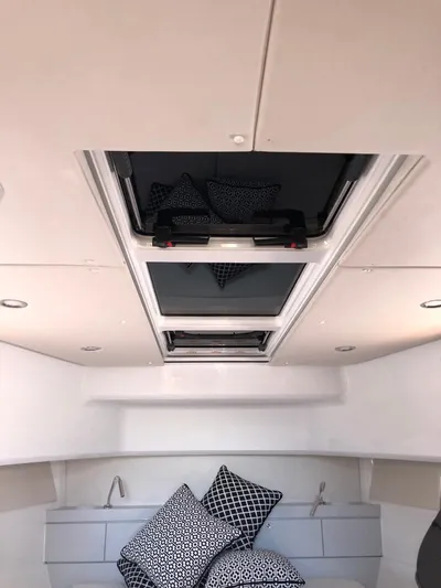  Yacht Photos Pics Interior of 2016 Fjord Open 48 yacht with skylight and patterned cushions.