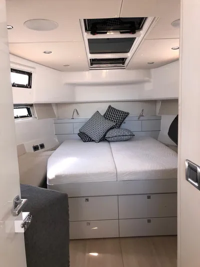  Yacht Photos Pics Luxurious cabin interior of 2016 Fjord Open 48 yacht with modern bedding.