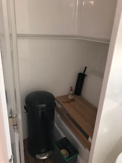  Yacht Photos Pics Small storage area on a 2016 Fjord Open 48 boat with cleaning supplies.