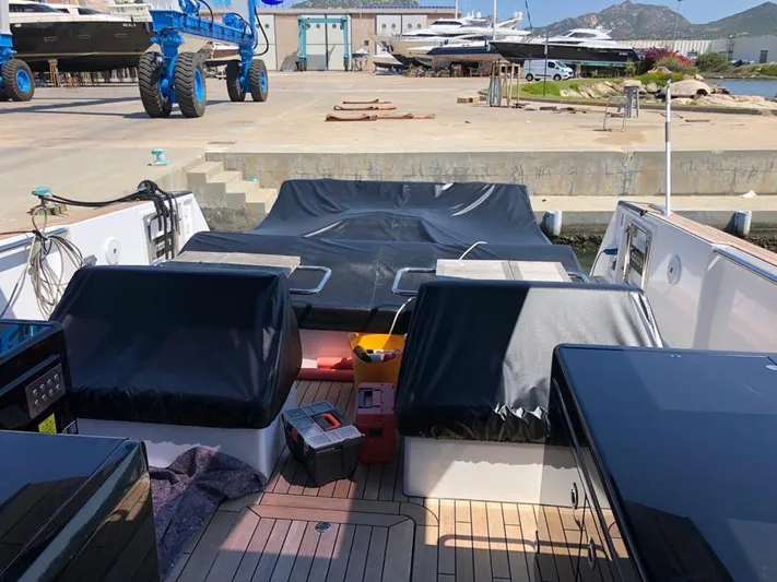  Yacht Photos Pics 2016 Fjord Open 48 yacht docked, featuring covered seating and deck area.