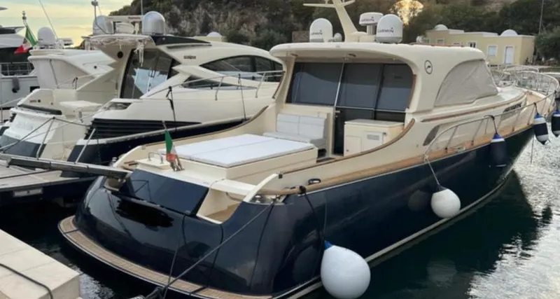  Yacht Photos Pics 2005 Mochi Craft 51 Dolphin yacht docked in a marina, featuring sleek design and luxury amenities.